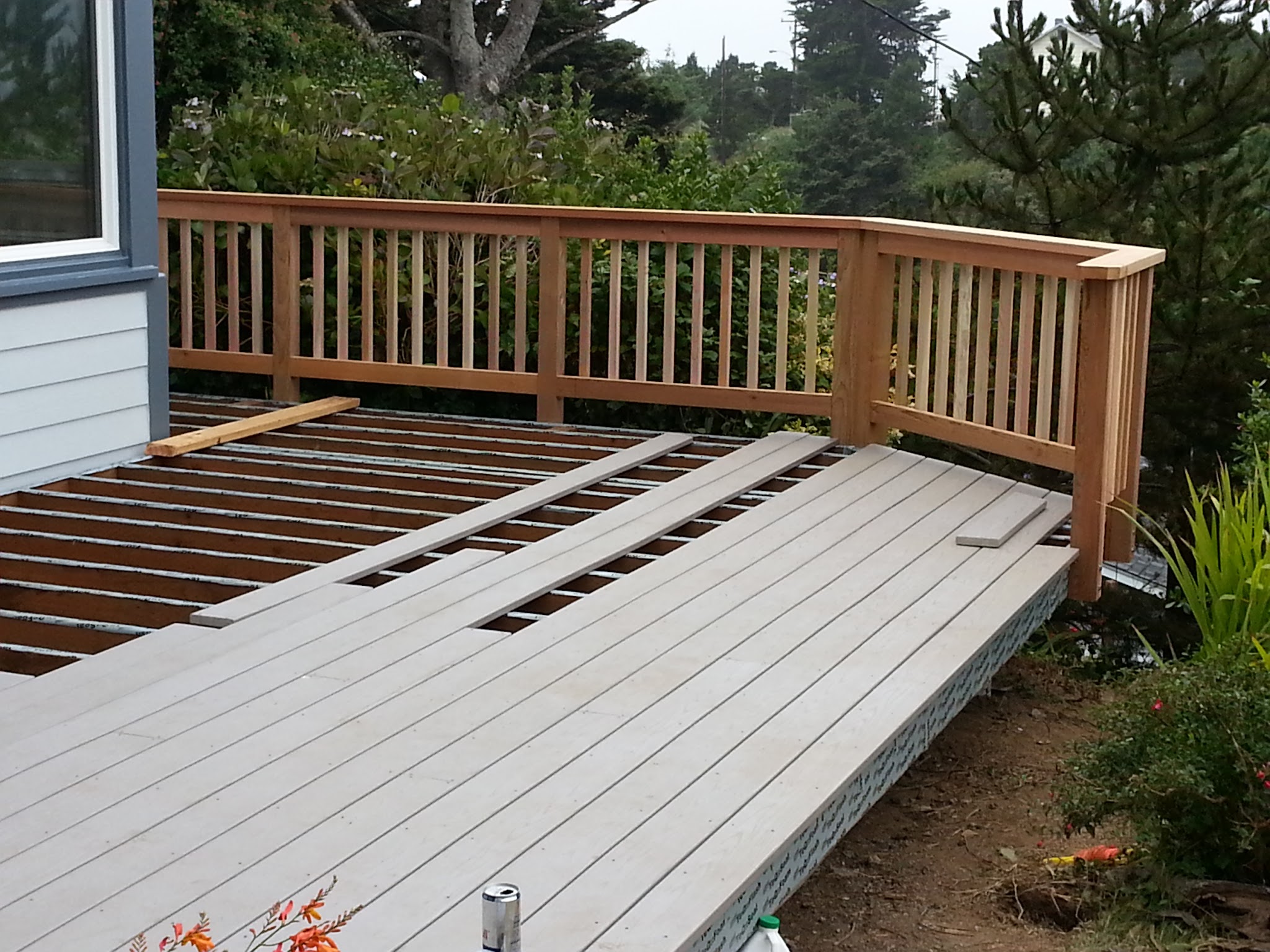 Composite decking being installed board by board