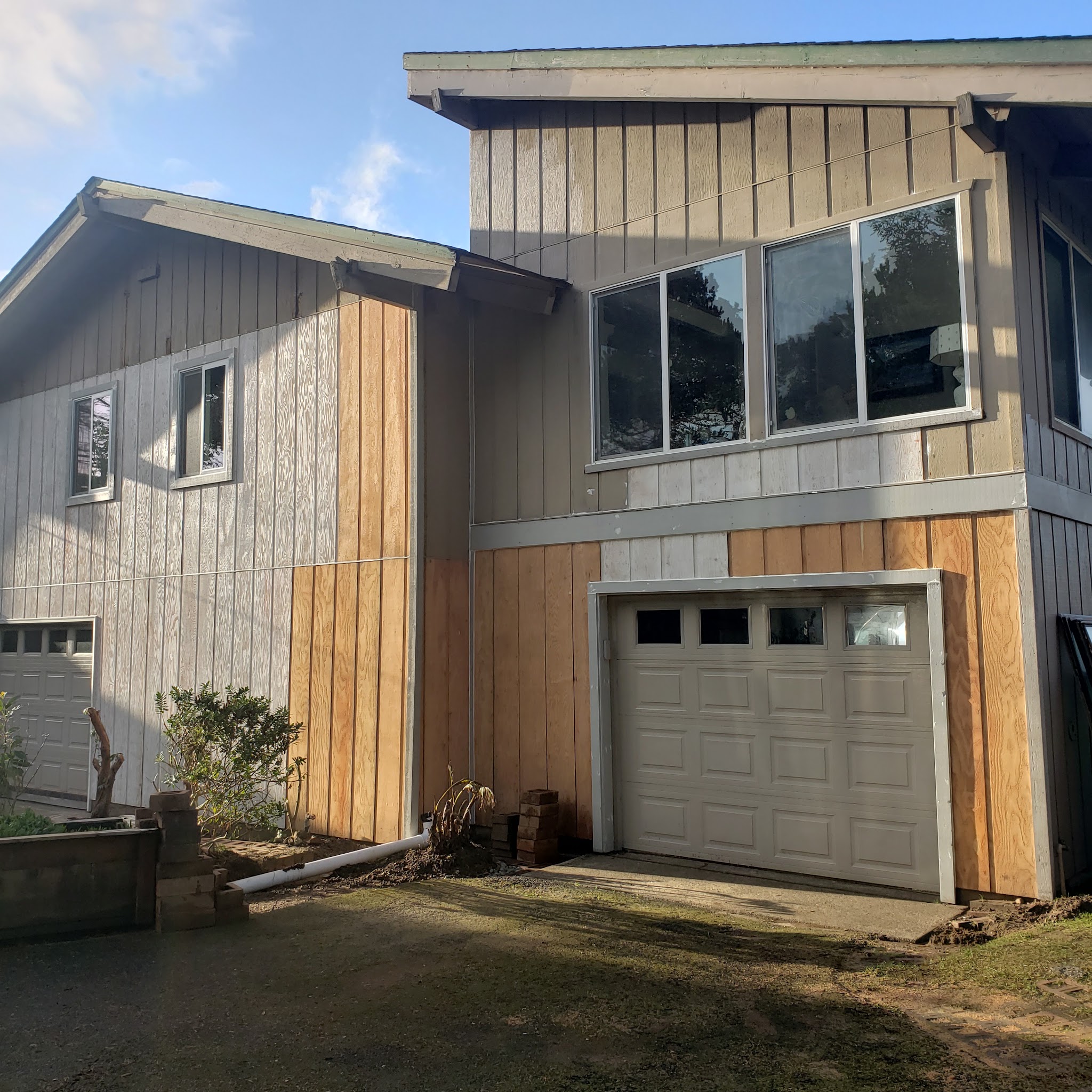 Siding replacement in progress on a two-story Newport home